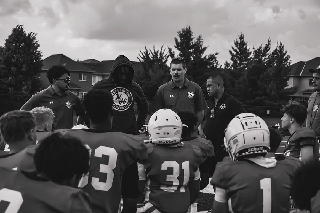 Tysen Pritchard with football players during a field session.